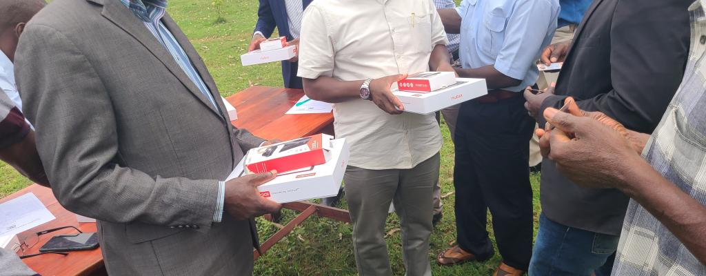 Deputy Cao and RDC handing over tablets from the ministry of ICT to the PDM secretariat.